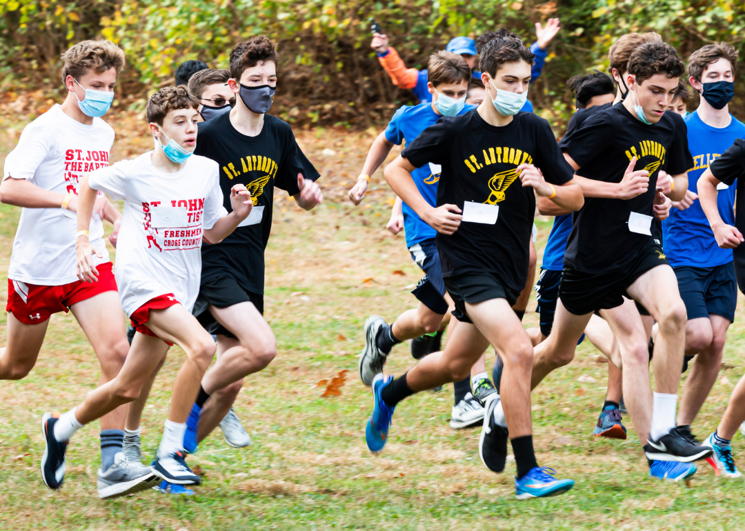 Syosset boys cross country race with many other teams.