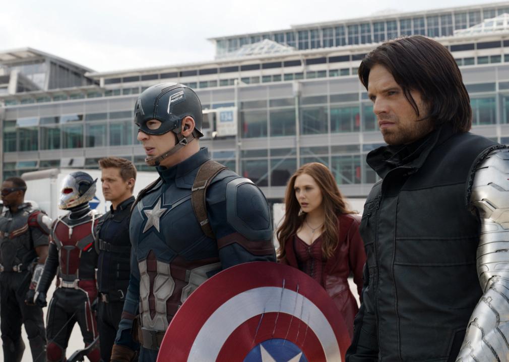 Captain America and other superheros stand staring into the distance.