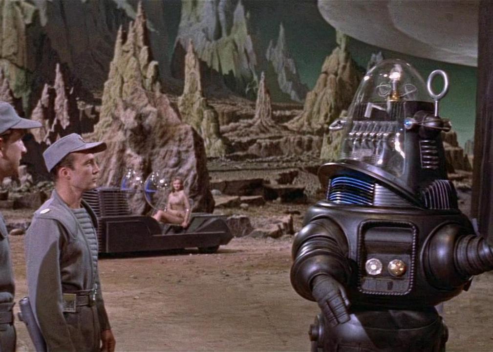 Men talking to a robot on another planet.
