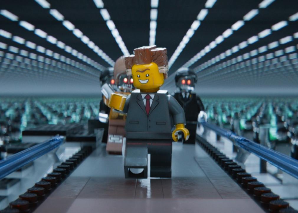 The Lego boss man walks through checking on all of his workers.