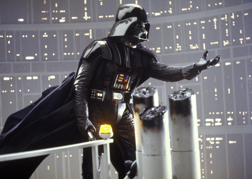 Darth Vader in all black with his hand held out.