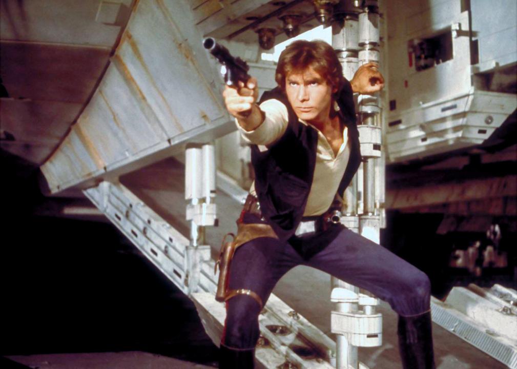 Han Solo aims his gun from underneath his spacecraft.