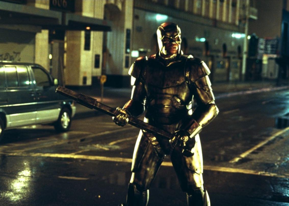 Shaquille O'Neal dressed as a superhero in the street.