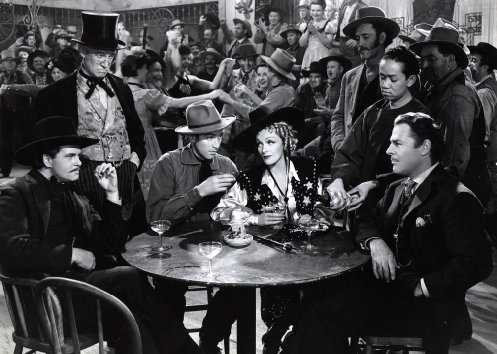 Marlene Dietrich, James Stewart, and Edmund MacDonald in a scene from "Destry Rides Again"