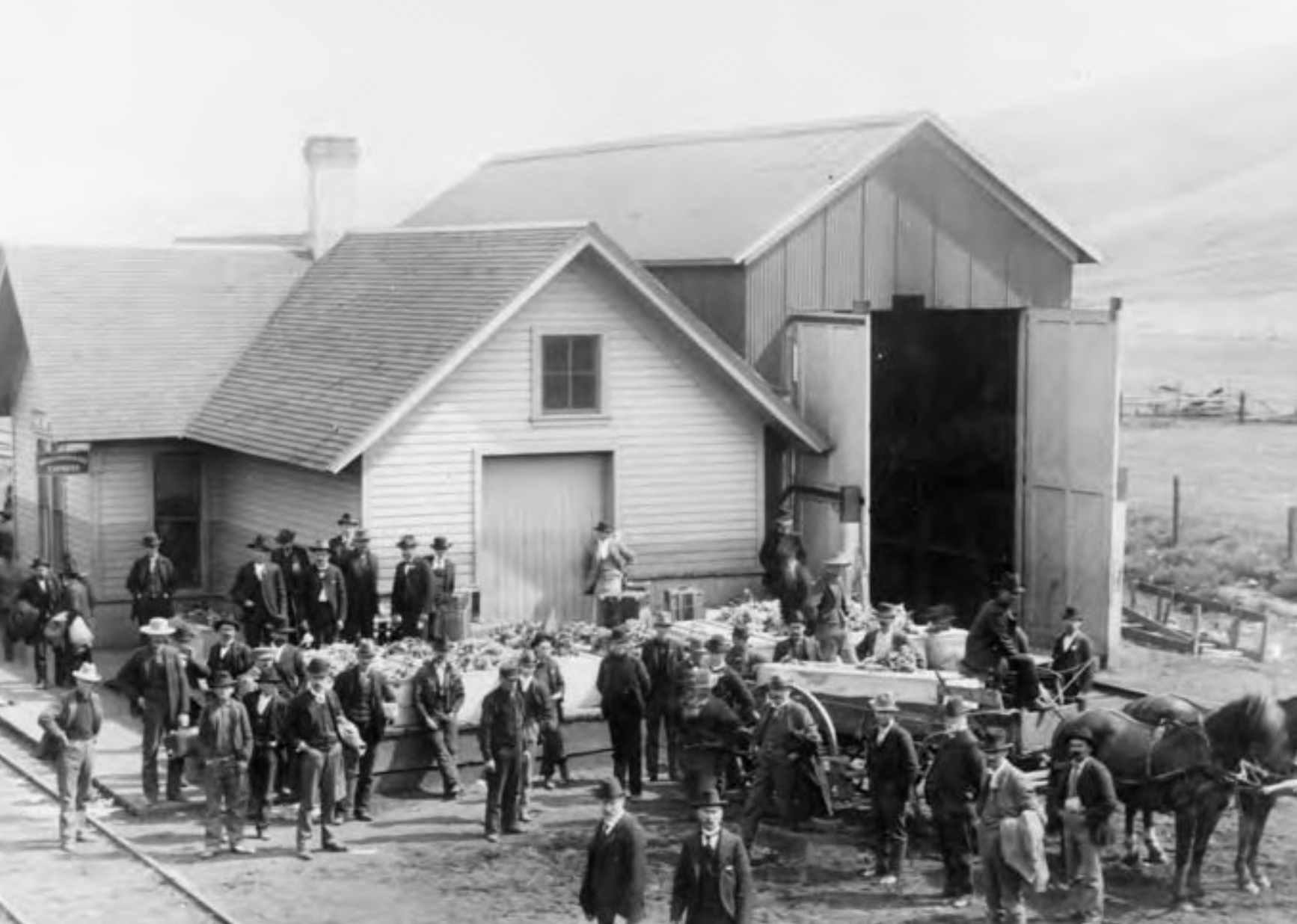 The coffins of the Winter Quarters workers waiting for the train to the cemetery. 