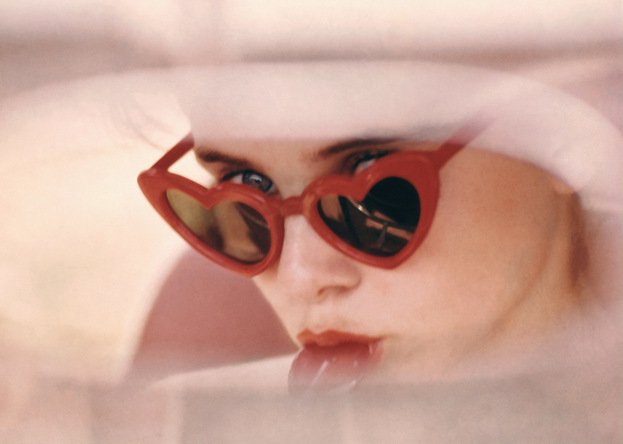 Sue Lyon as Lolita wearing iconic red heart shaped sunglasses in a publicity shot for the movie. 