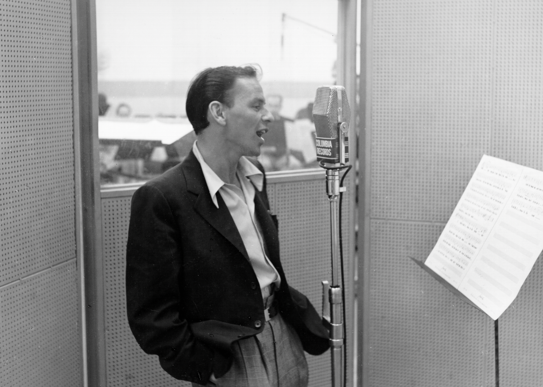 Frank Sinatra records in the studio at a Columbia Records microphone.