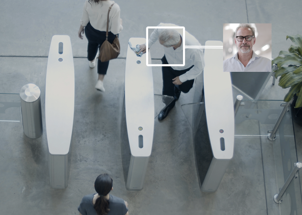 Overhead shot of security gates identifying people with facial recognition technology at entrance.