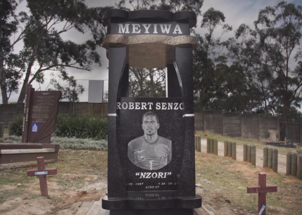 A tall, black gravestone reading "Robert Senzo".