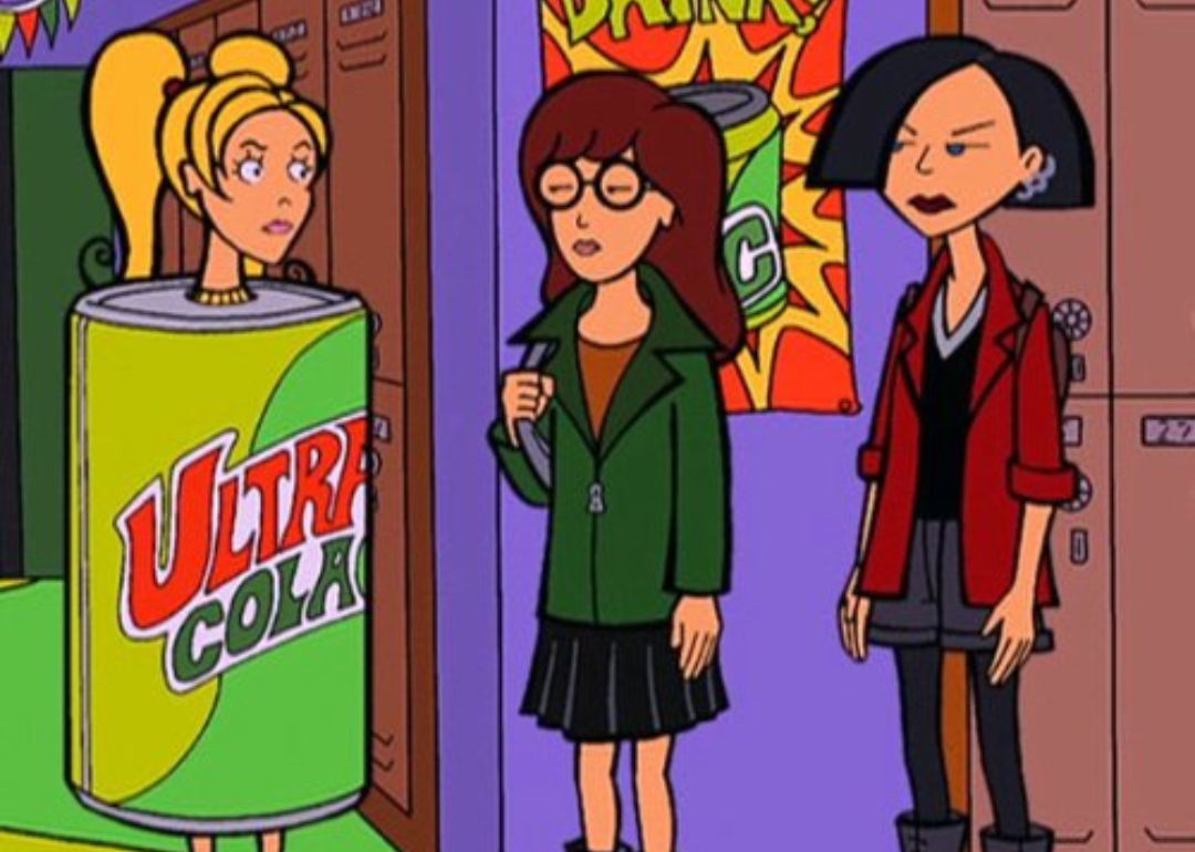 Three girls in a hallway at school, one wearing a soda can as a costume.