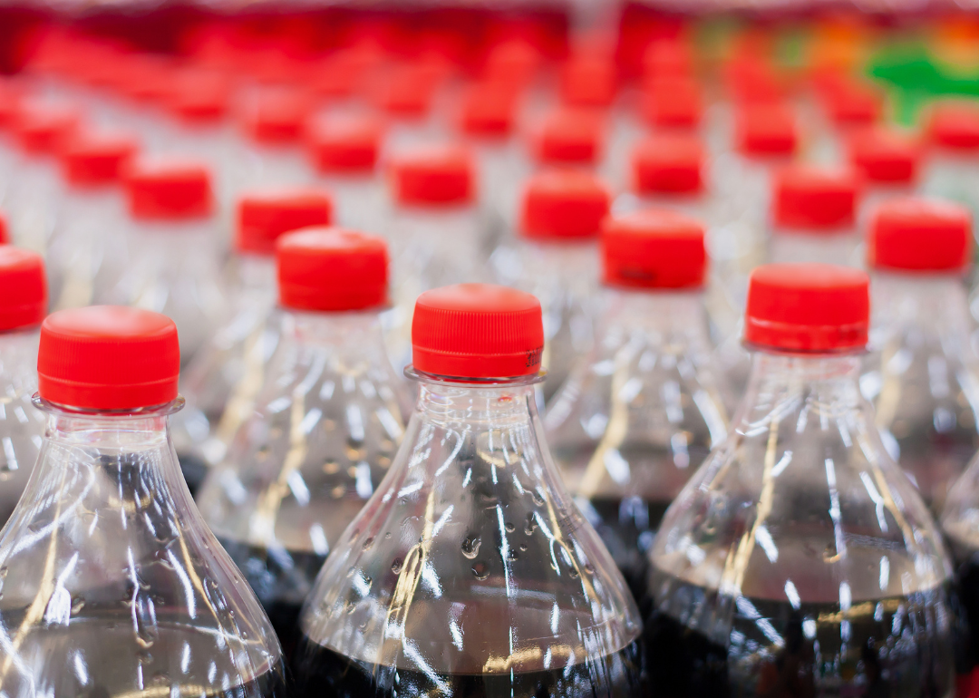 Rows of soda bottles with red tops.