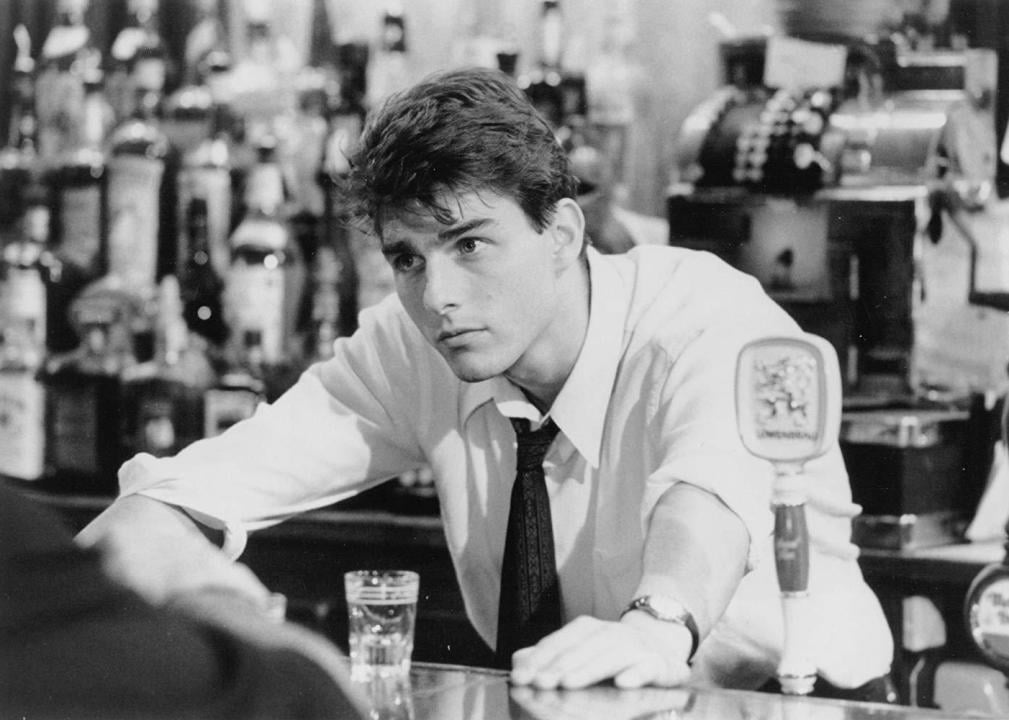 Tom Cruise as a bartender in a black and white image.