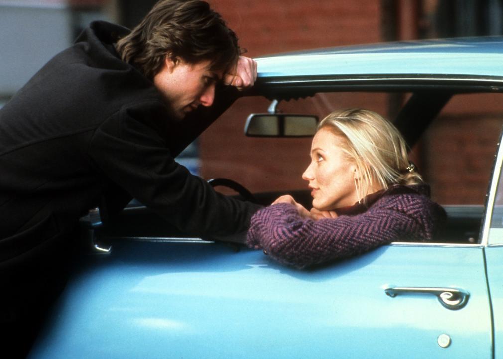 Tom Cruise talks to Cameron Diaz as she sits in a blue classic car.