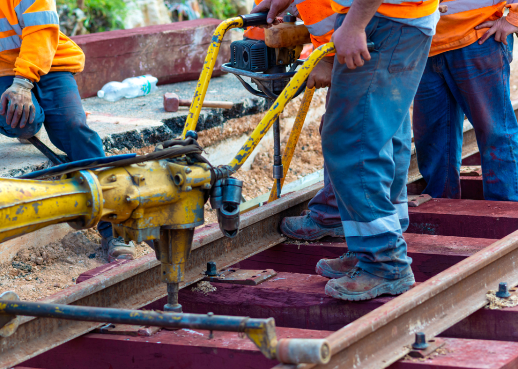 Railway workers bolting track rail.