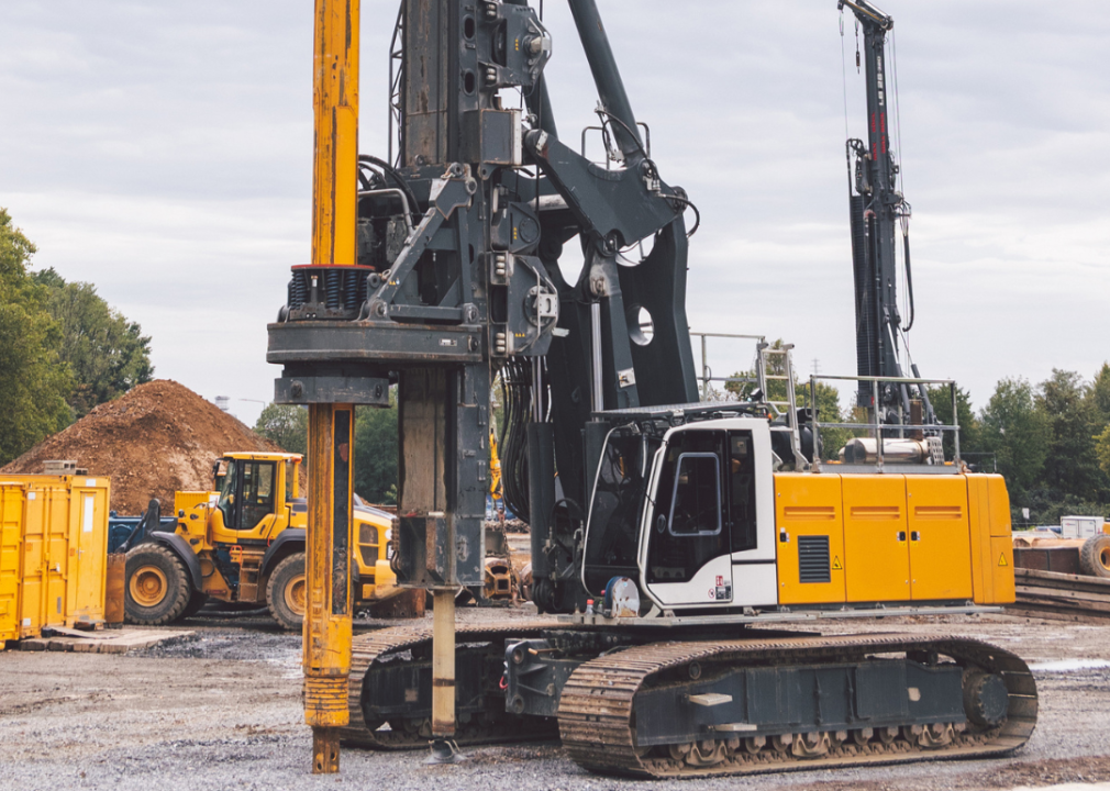 Yellow vertical pile driver machine.