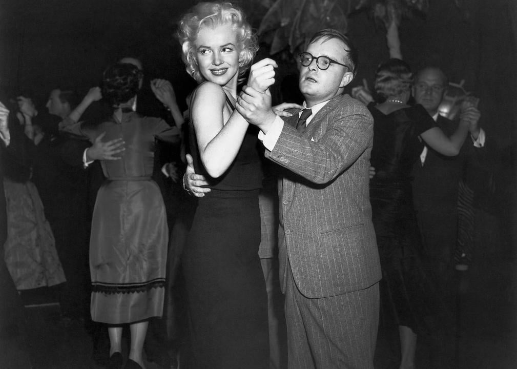 Truman Capote dancing with Marilyn Monroe.