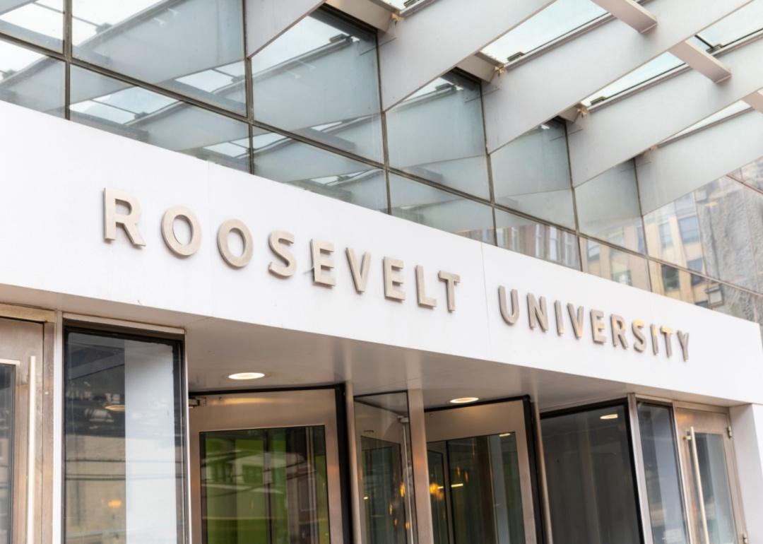 A white building with glass doors and a sign for Roosevelt University.