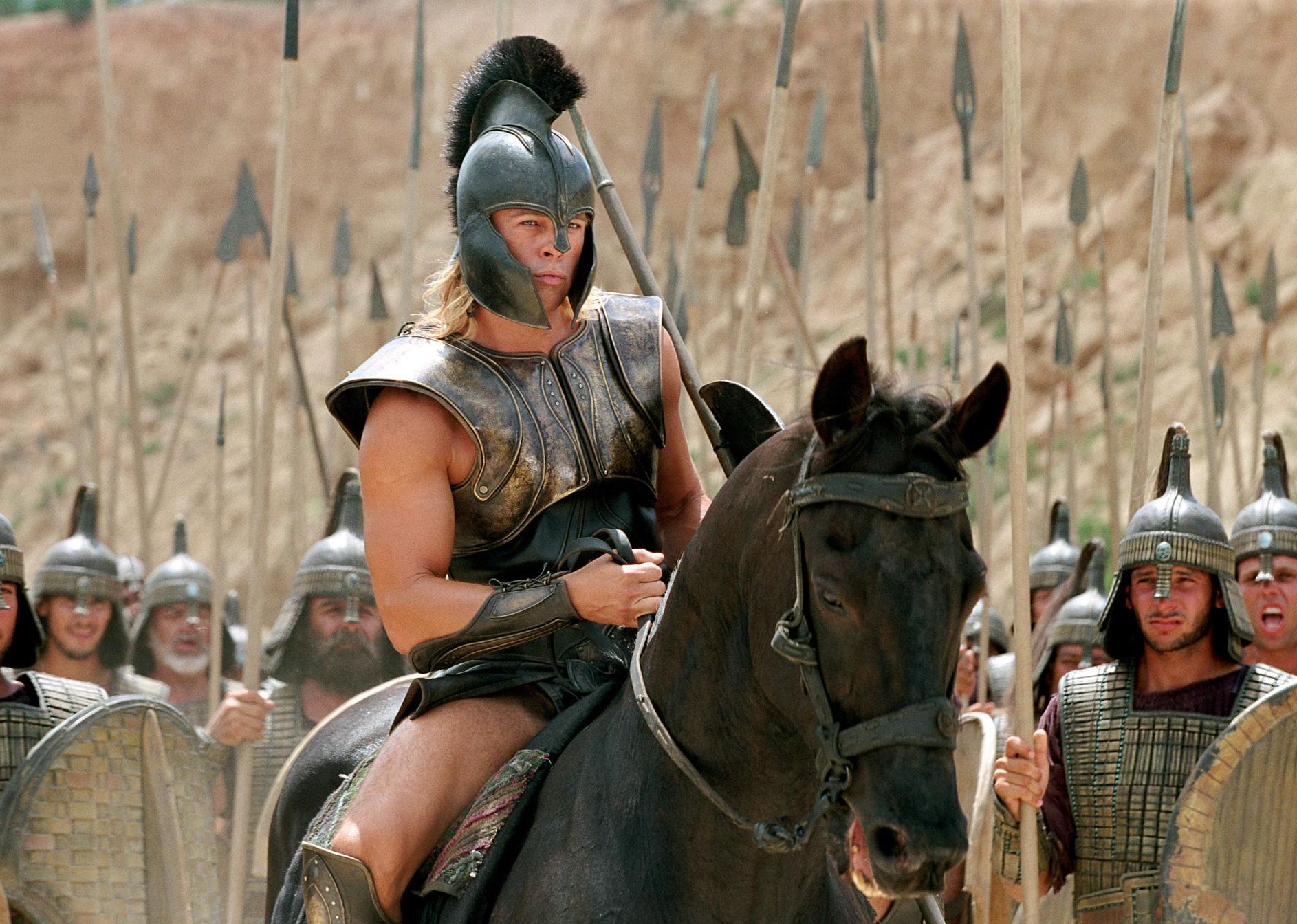 Brad Pitt dressed in Trojan armor on horseback.