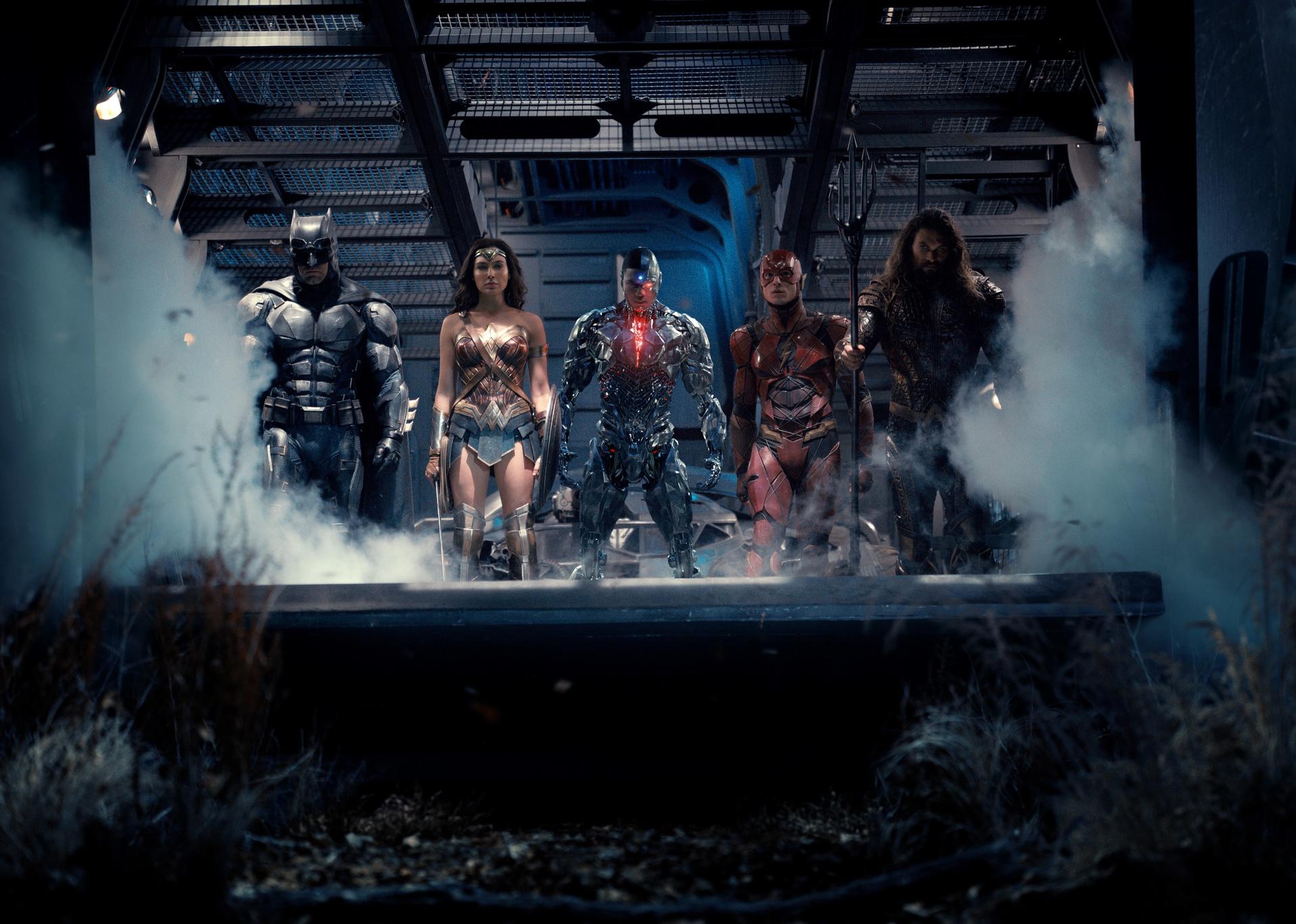 Ben Affleck, Jason Momoa, Gal Gadot, Ezra Miller, and Ray Fisher in various superhero costumes.