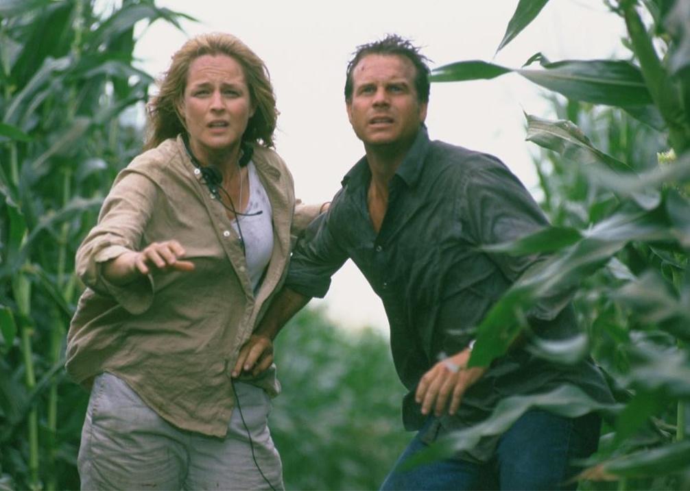 Helen Hunt and Bill Paxton in a windy cornfield looking up into the sky.