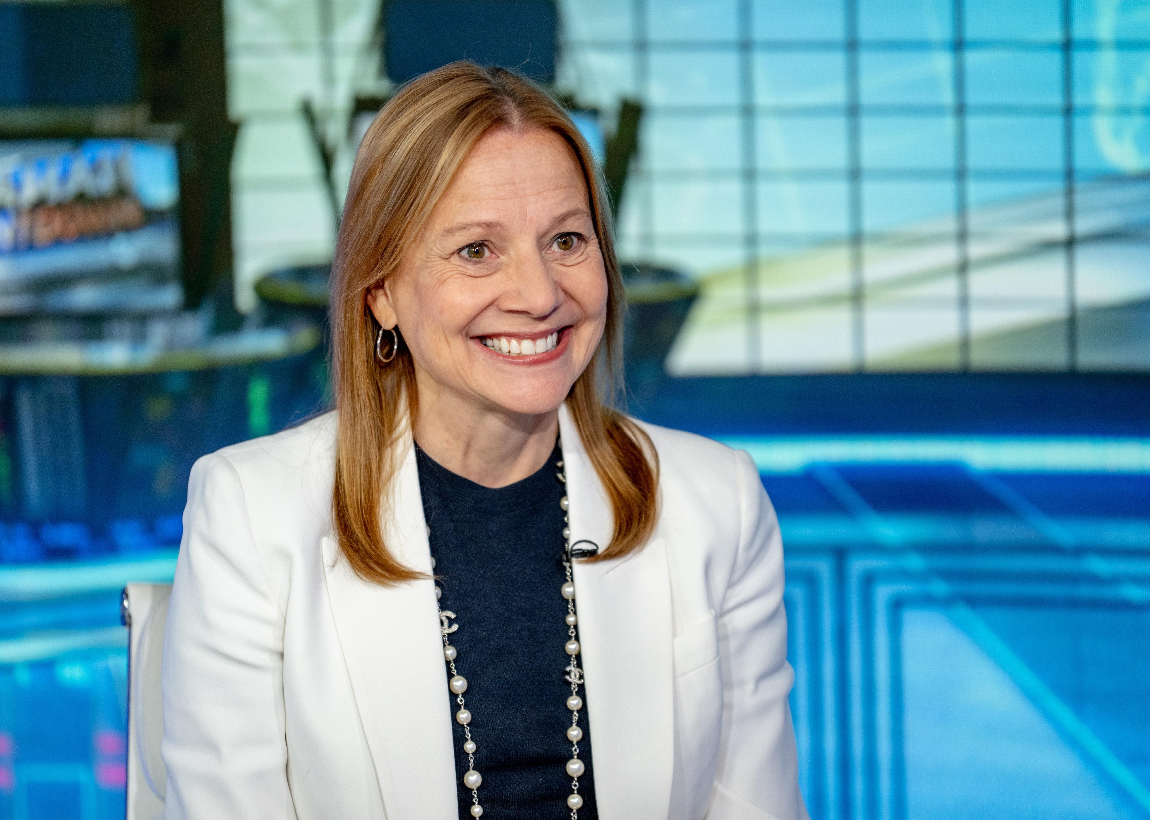 Mary Barra smiling in a news studio.