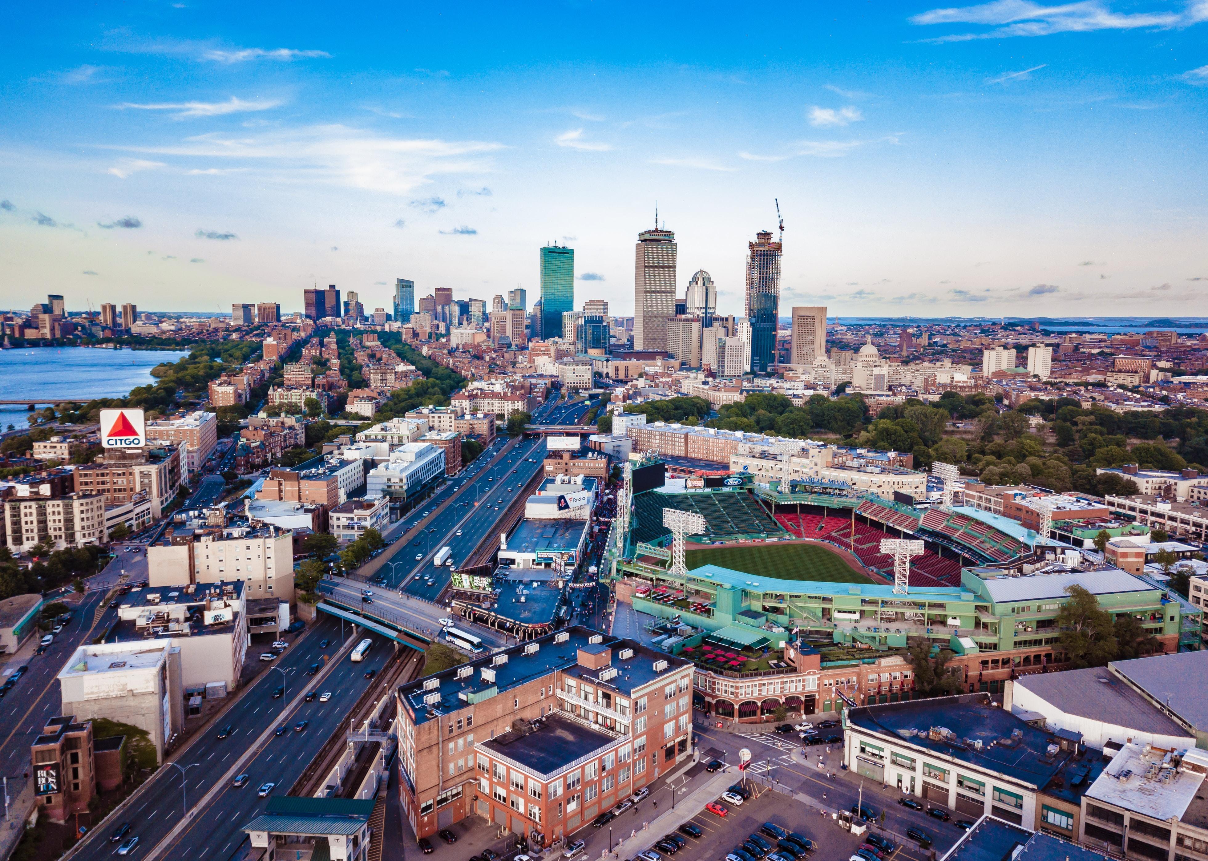 Aerial view of Fenway Park, foreground, and downtown Boston.