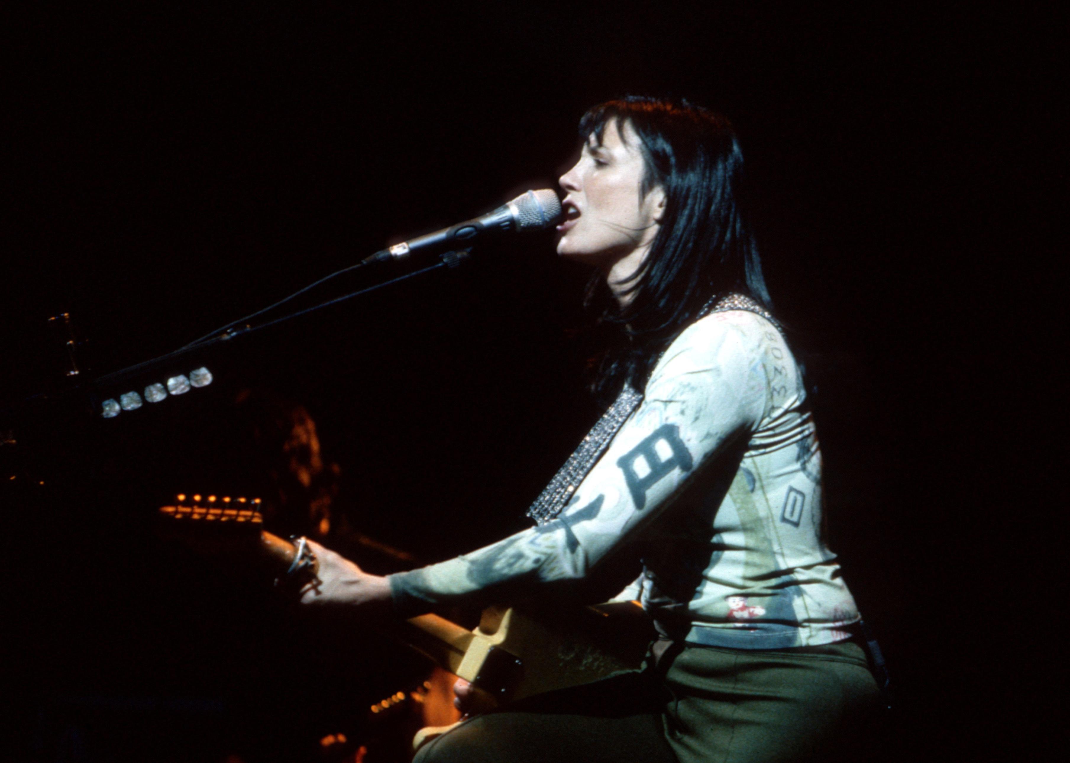 Meredith Brooks performs on stage.