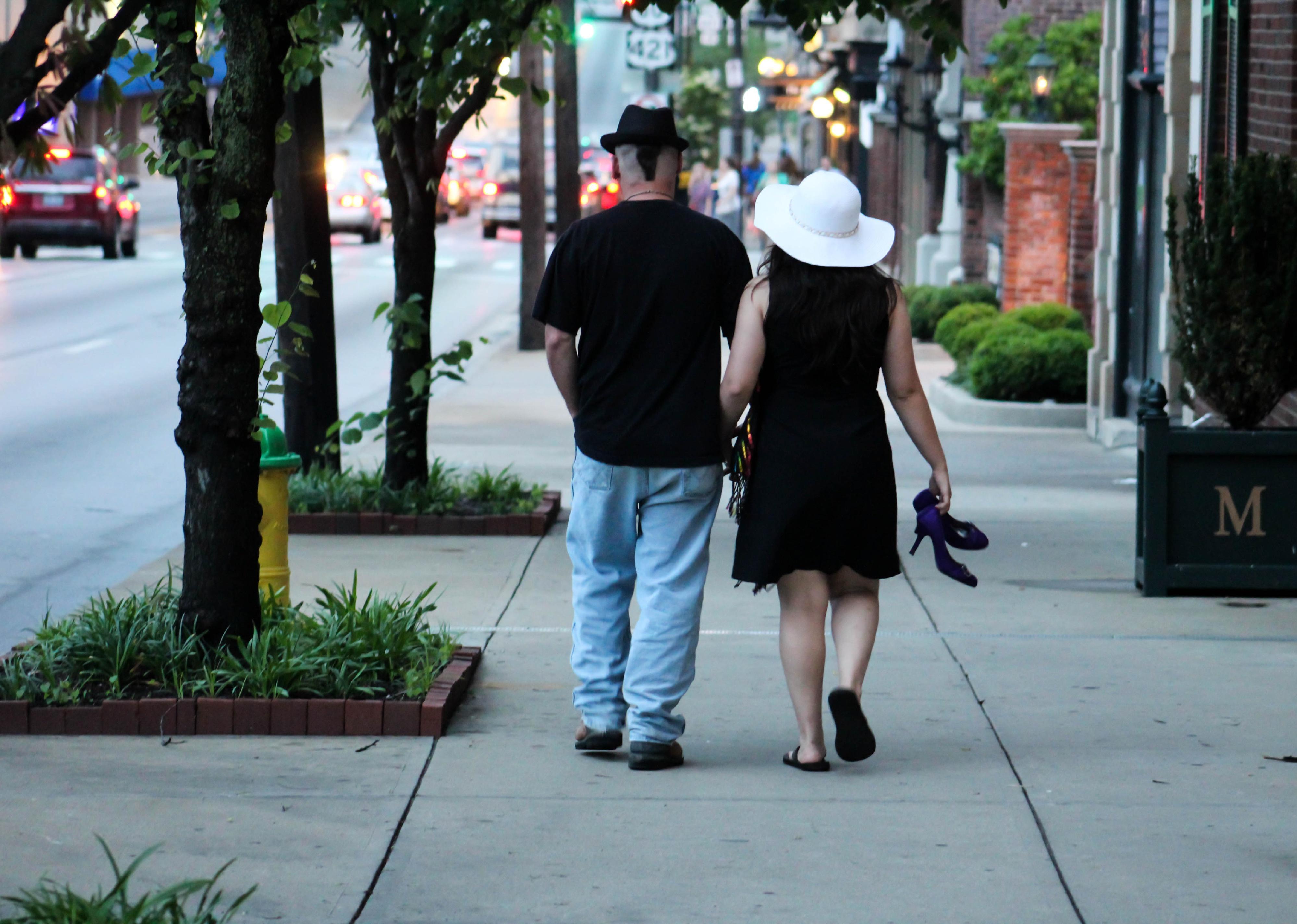A couple walks down a street in Lexington, Kentucky.