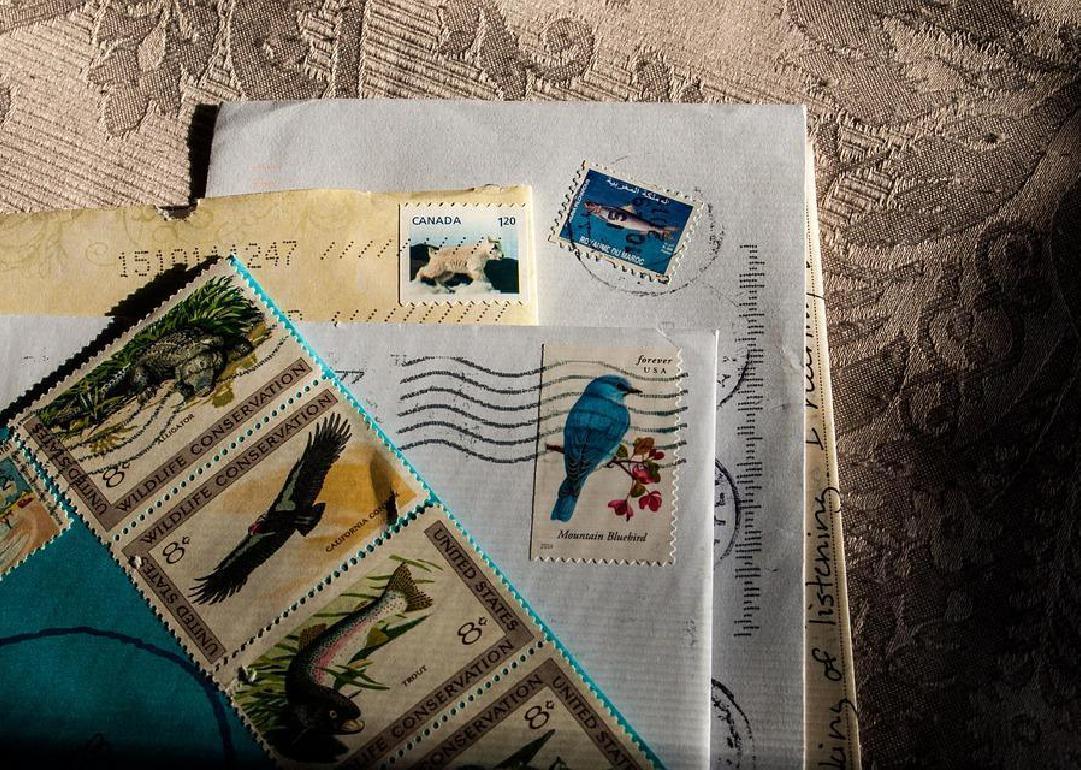 A small stack of postmarked letters and stamps. 