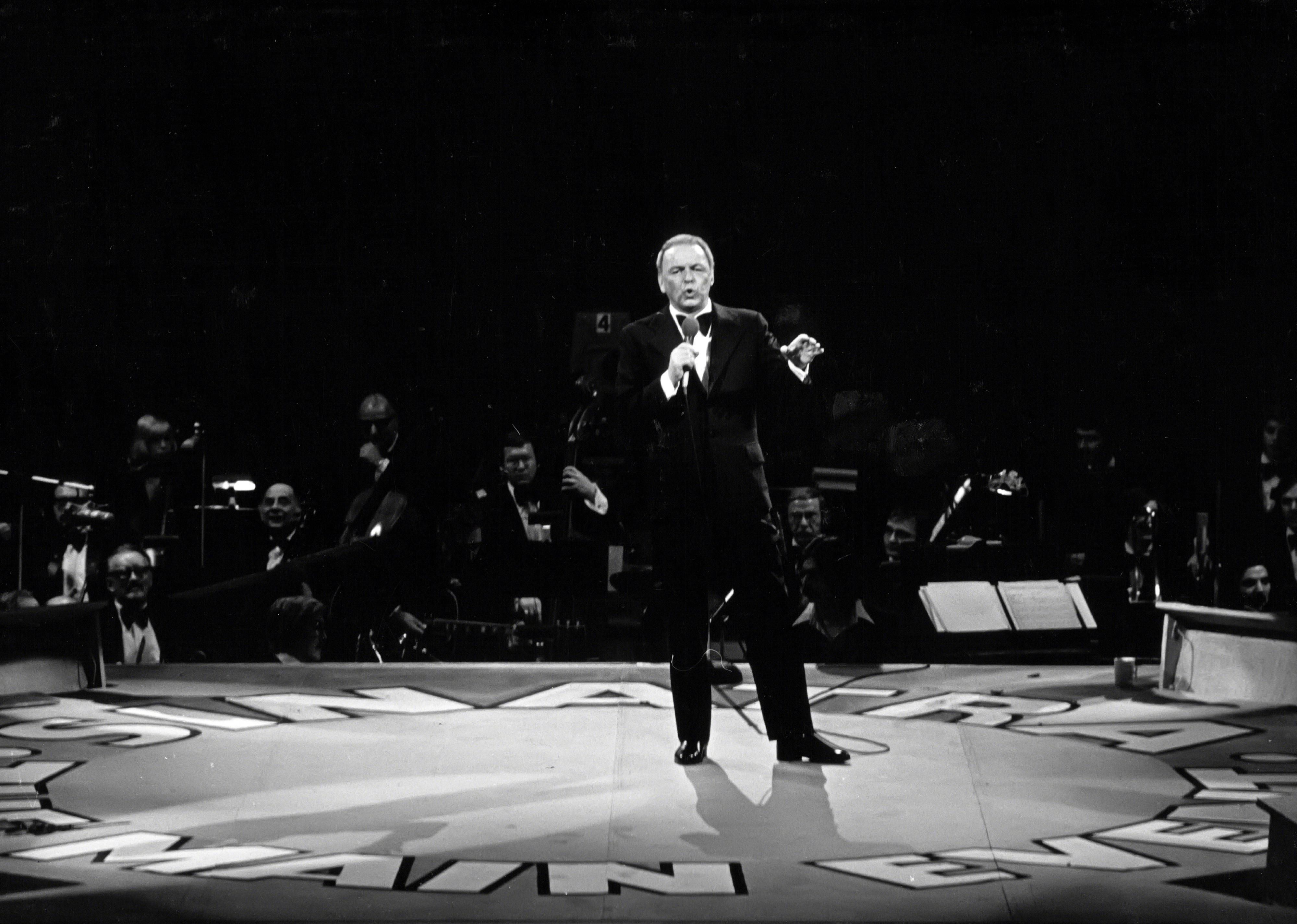 Frank Sinatra performing onstage.
