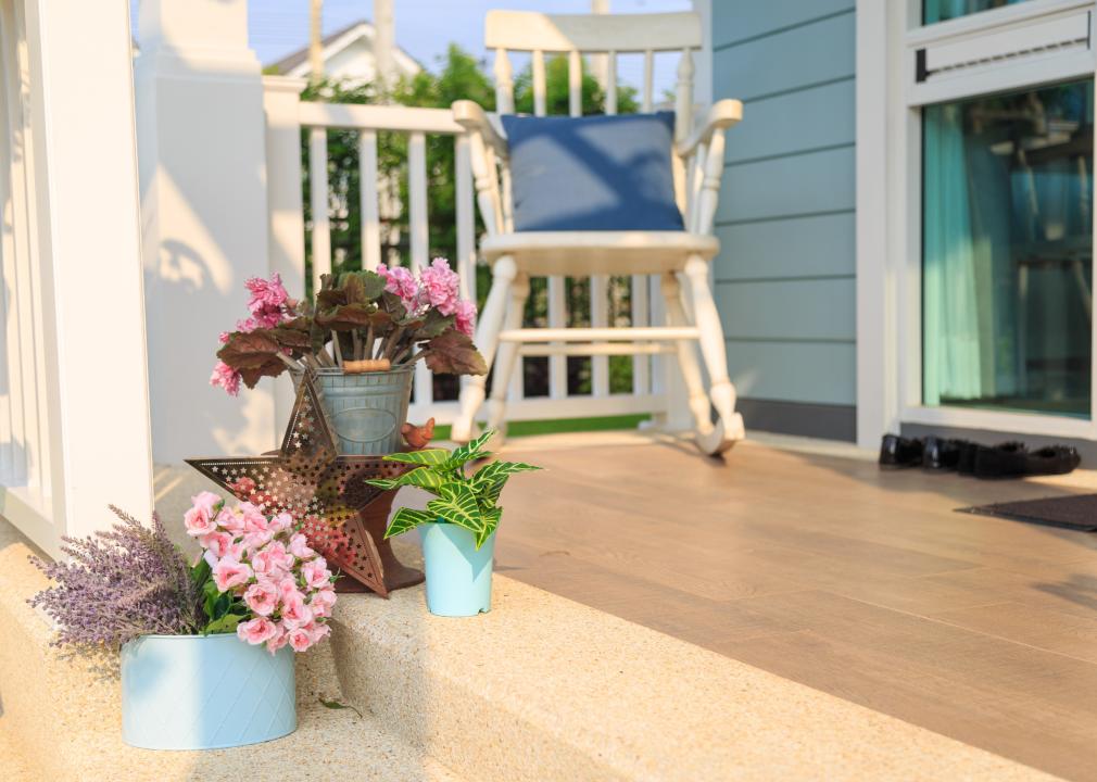 Flower pots displayed on a front porch.