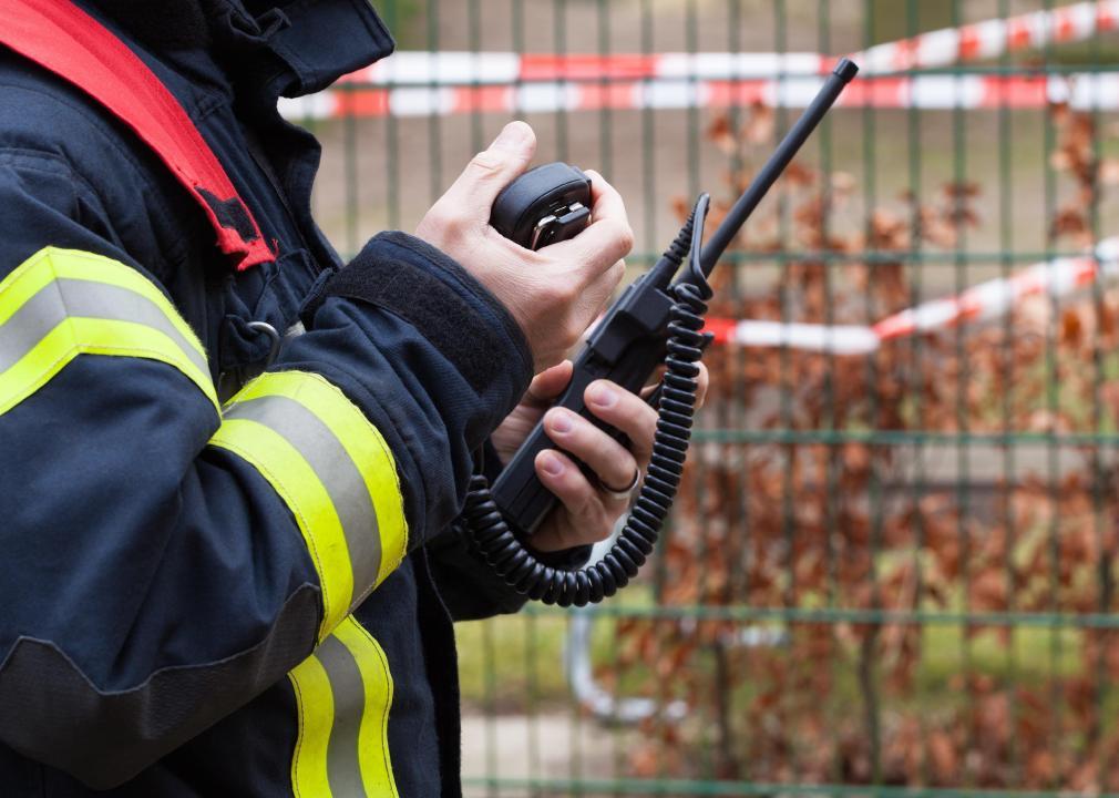 An emergency technician speaks into a walkie talkie.