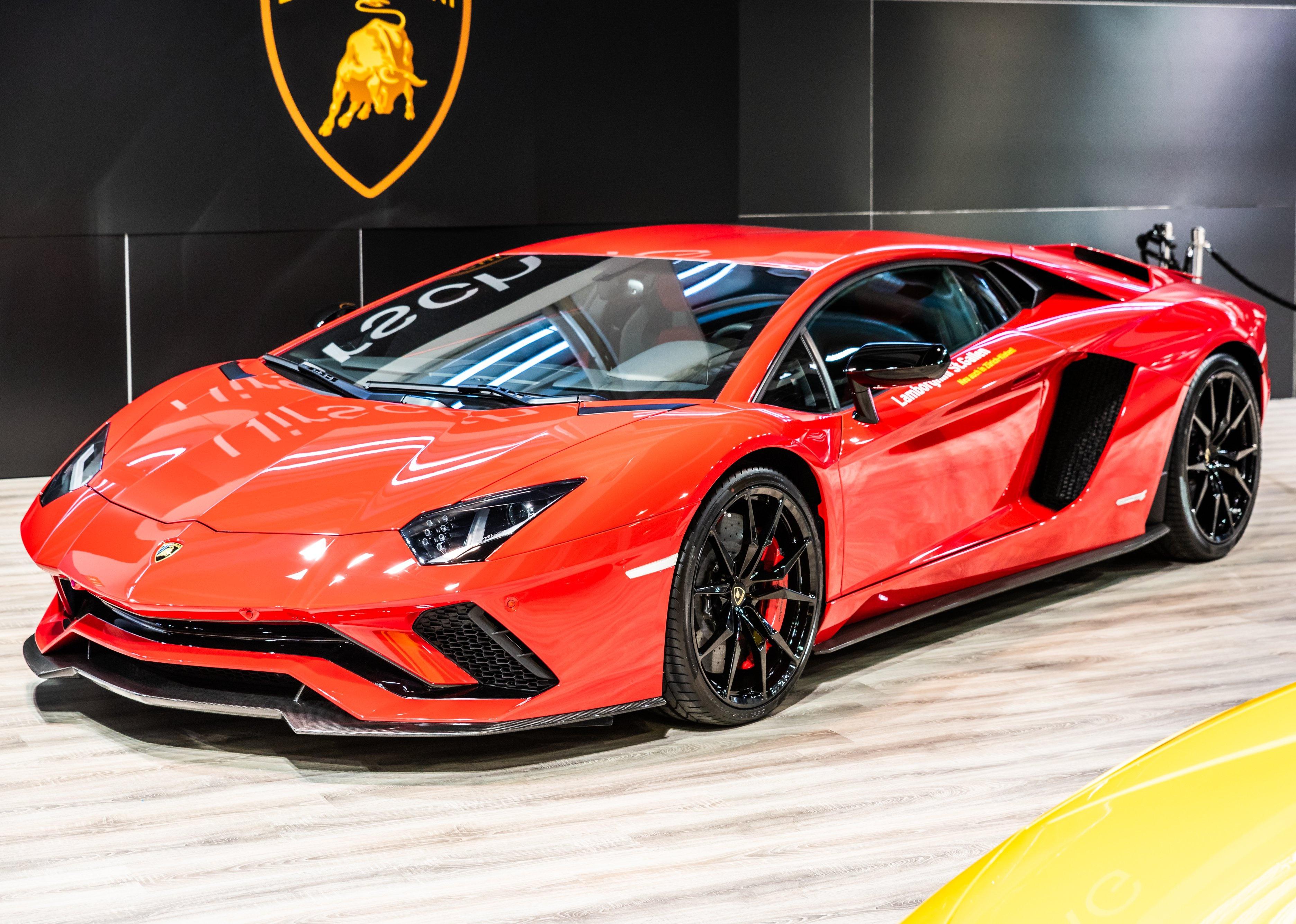 Front side view of a Rosso Mars red Lamborghini Aventador S LP740-4 Coupe.