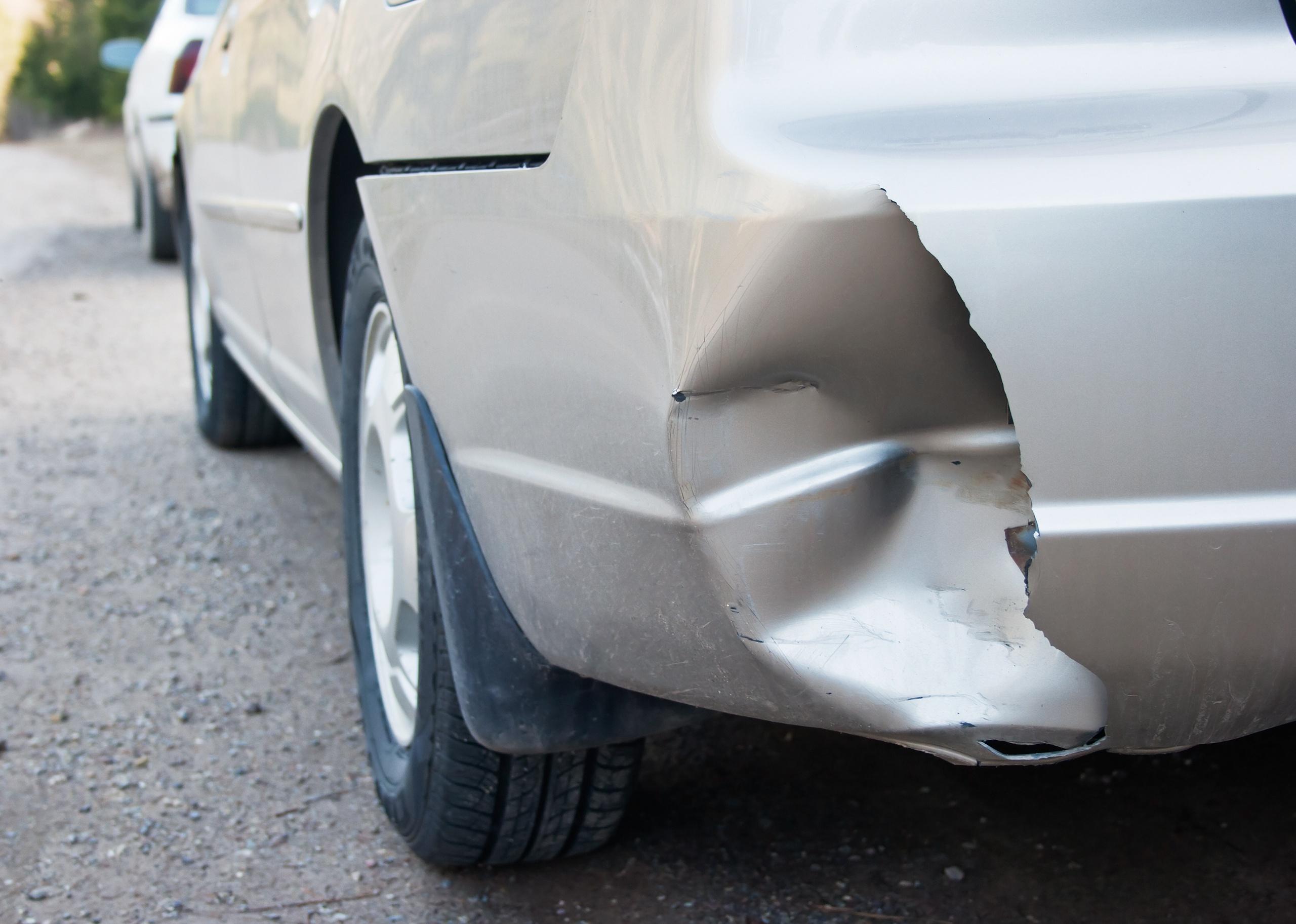 A car with a dented rear bumper in an accident
