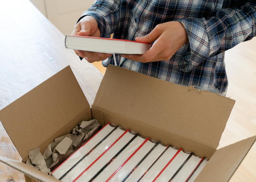 Person opening a shipment of books