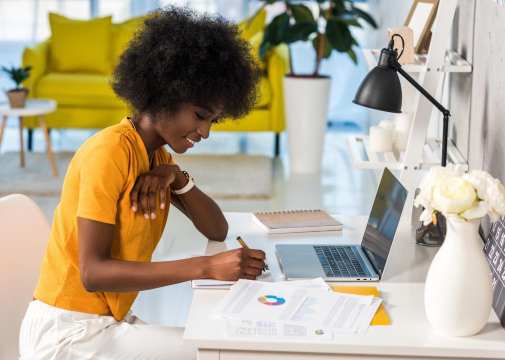 Side view of african american female working at home