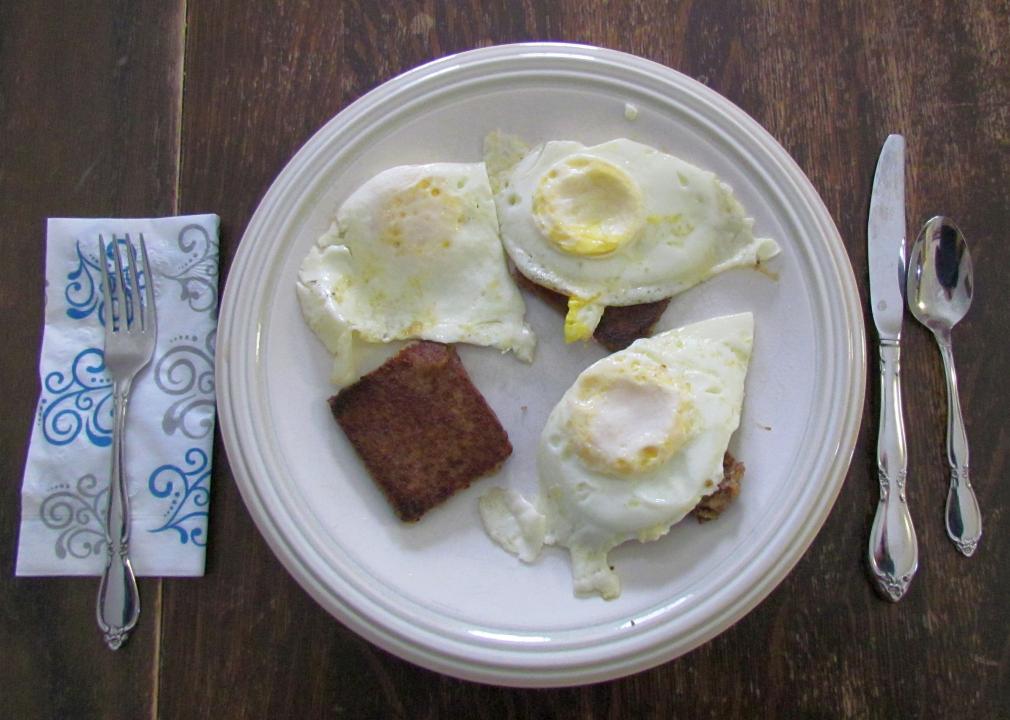 Over-hard eggs on fried scrapple.