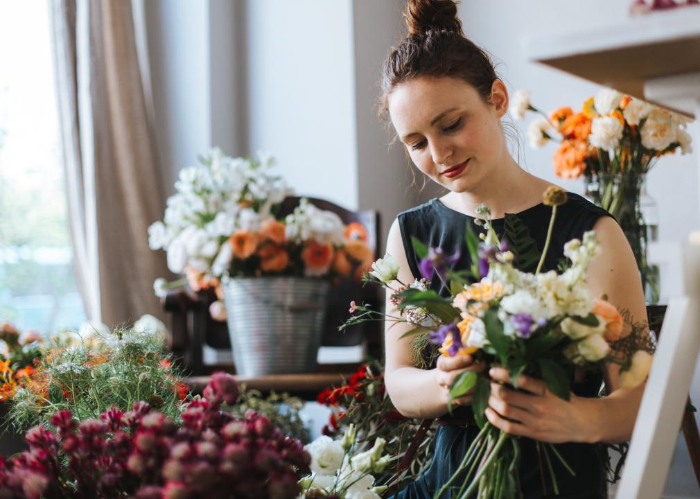 Florist arranging a bouquet of colorful flowers