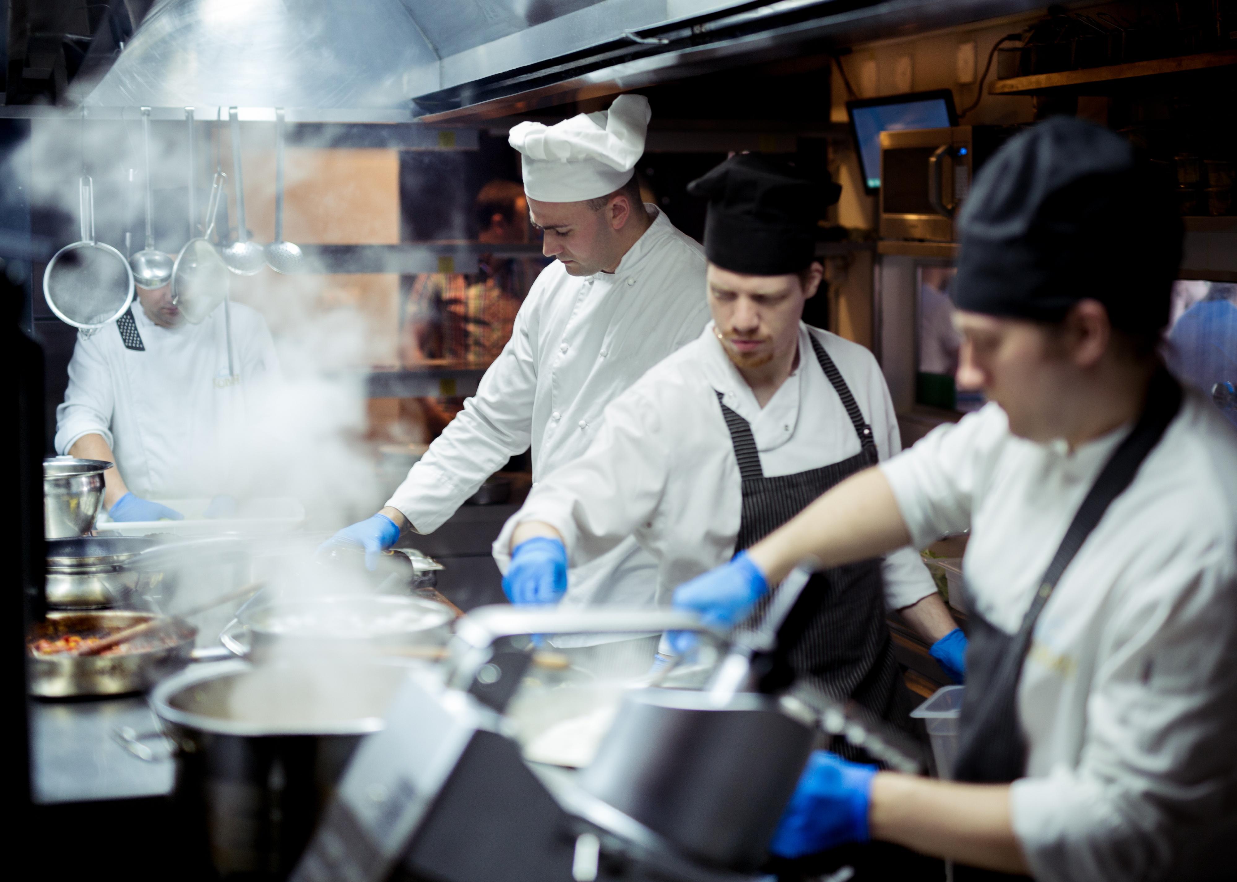 Group of chefs working in a kitchen.