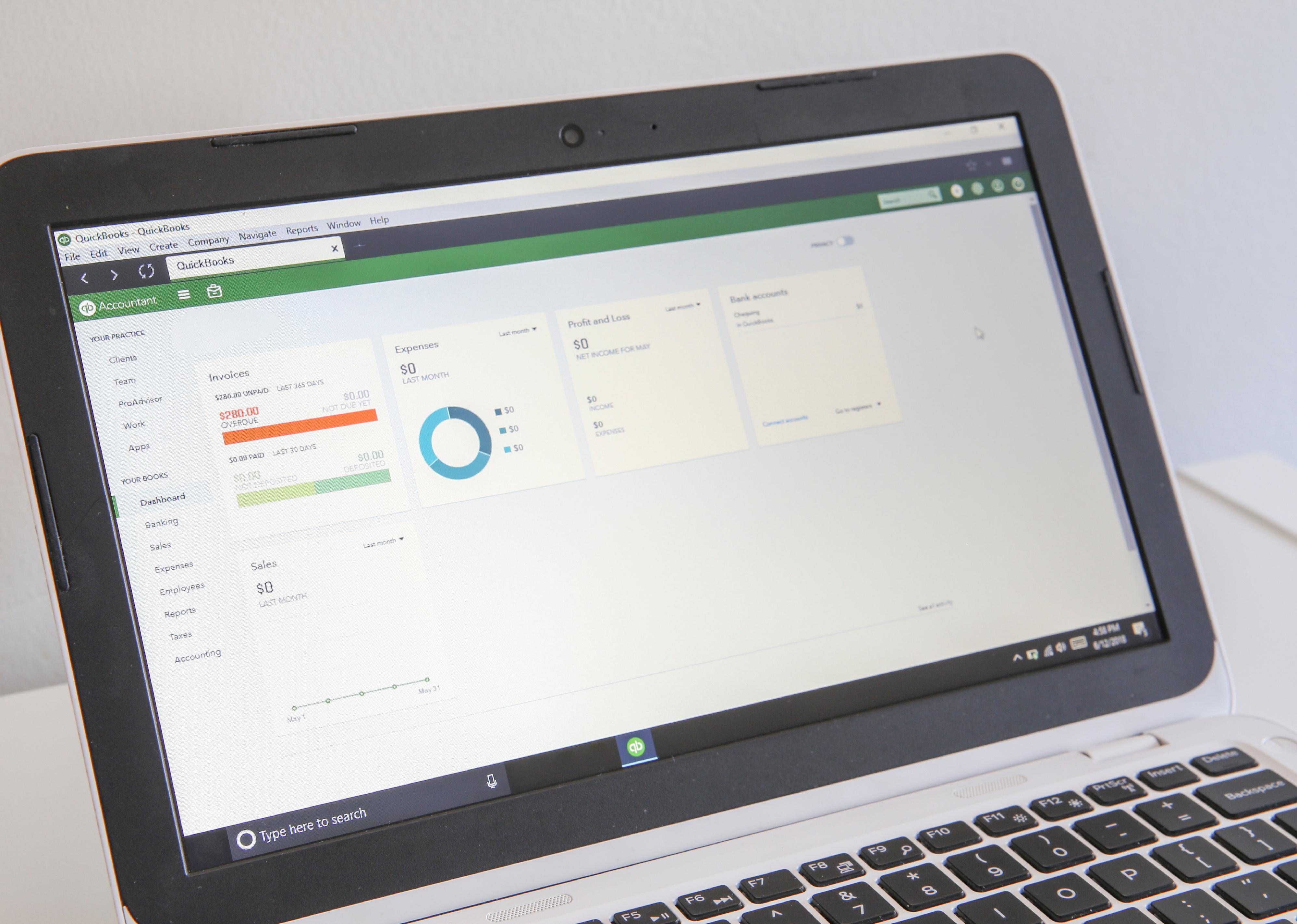 QuickBooks software displayed on laptop.