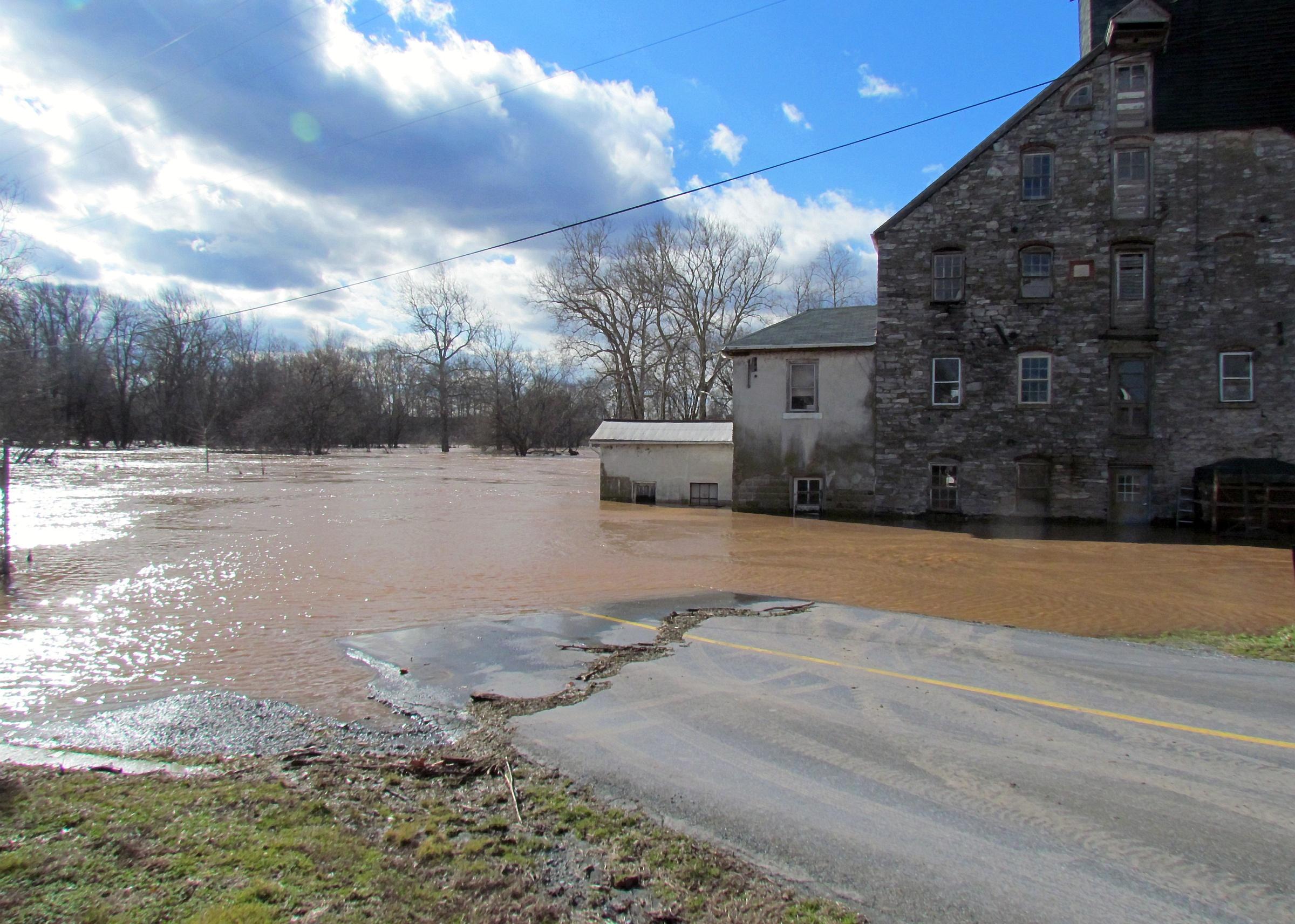 The flooded Conestoga River enters a water powered flour mill near Leola, PA.
