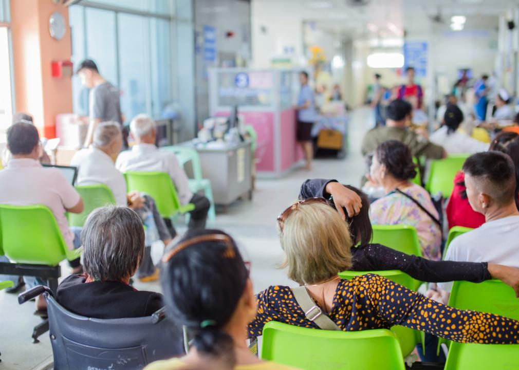 Blurred image of patients in a hospital waiting room.