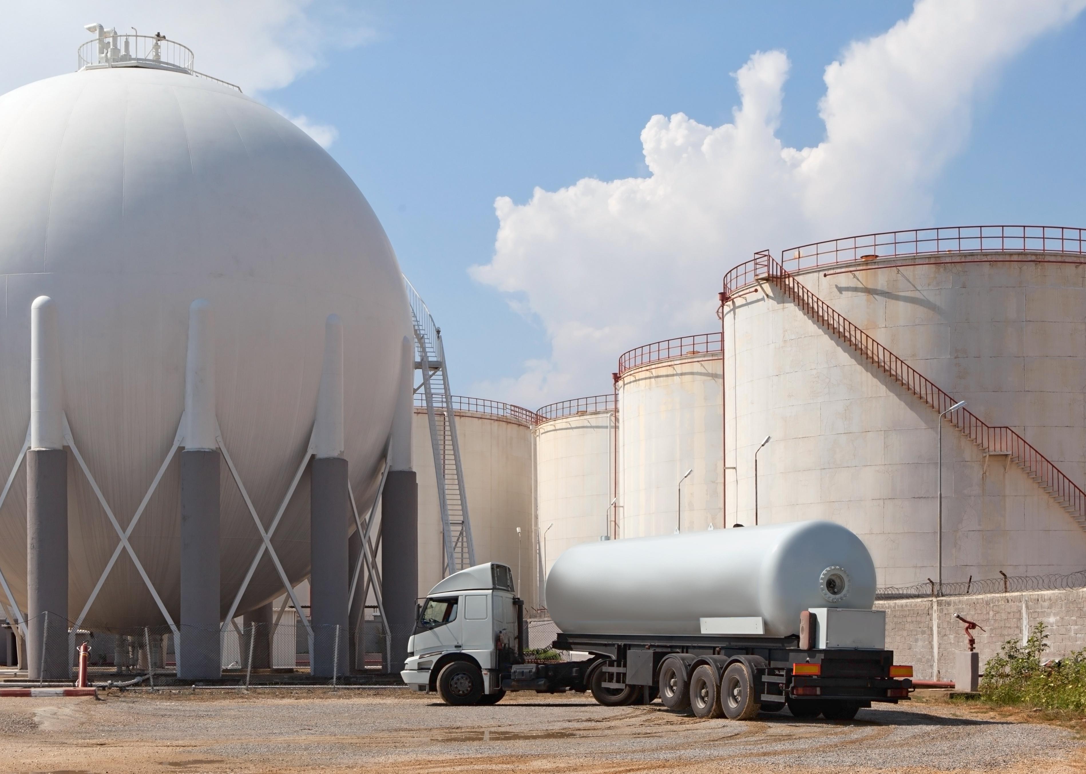 Workers load a tanker with liquefied natural gas.