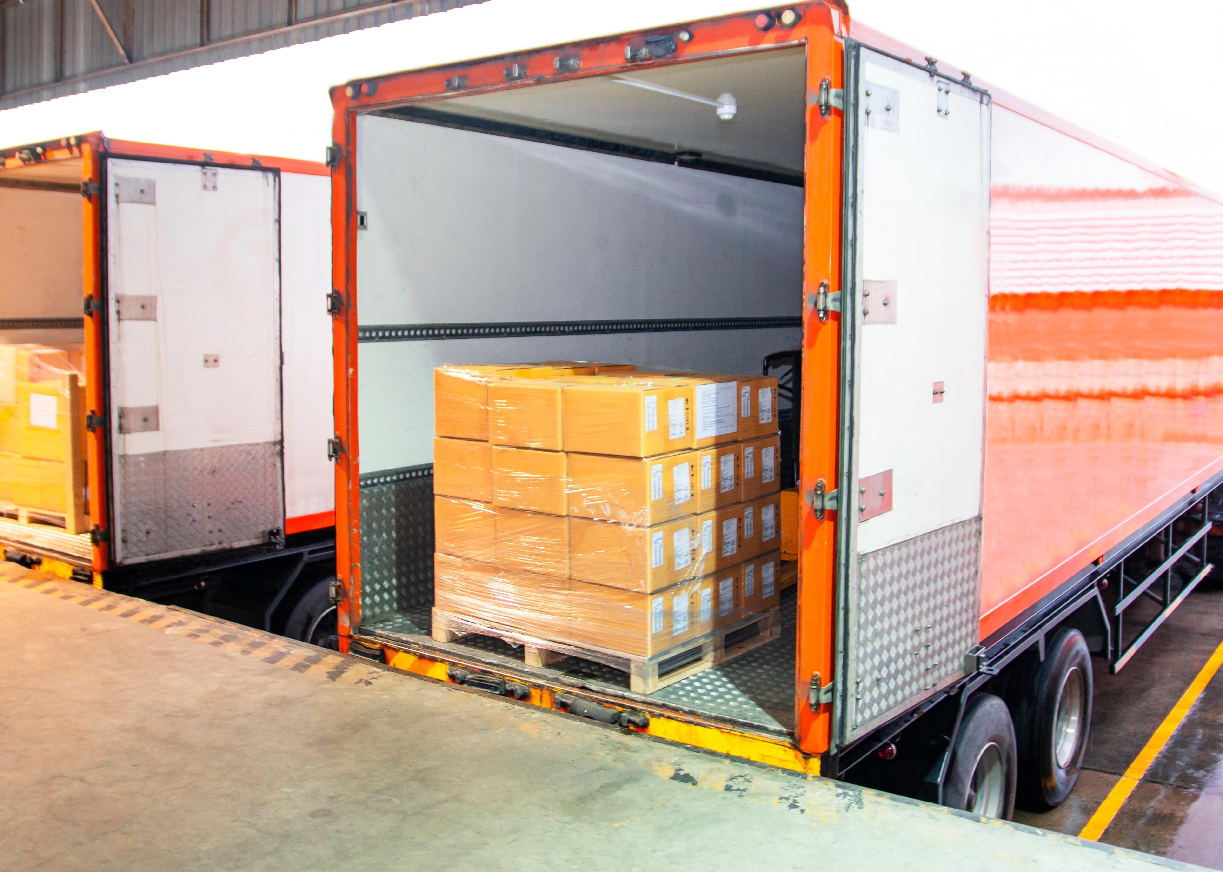 Stacked package boxes on pallet inside a truck.