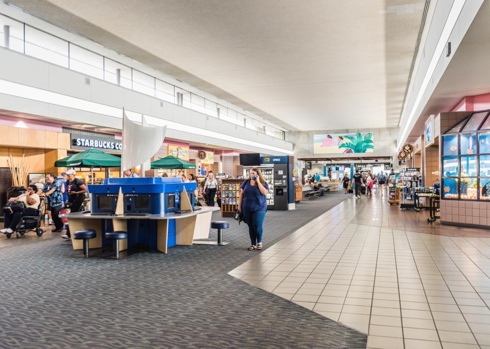 Shops and passengers inside Honolulu Airport.