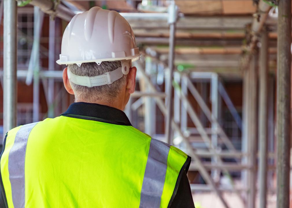 Rear view of male construction worker wearing hard hat
