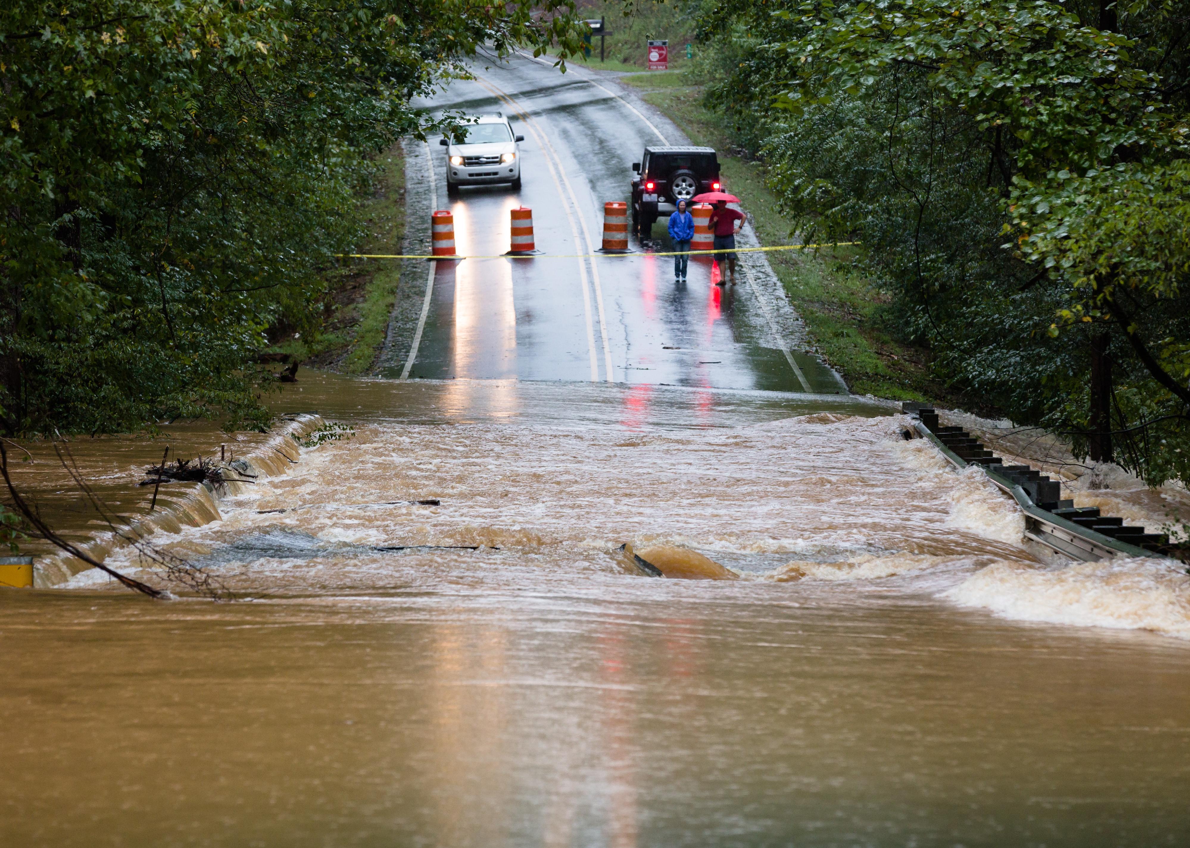 Motorists inspect a road flooded in Waxhaw, North Carolina.