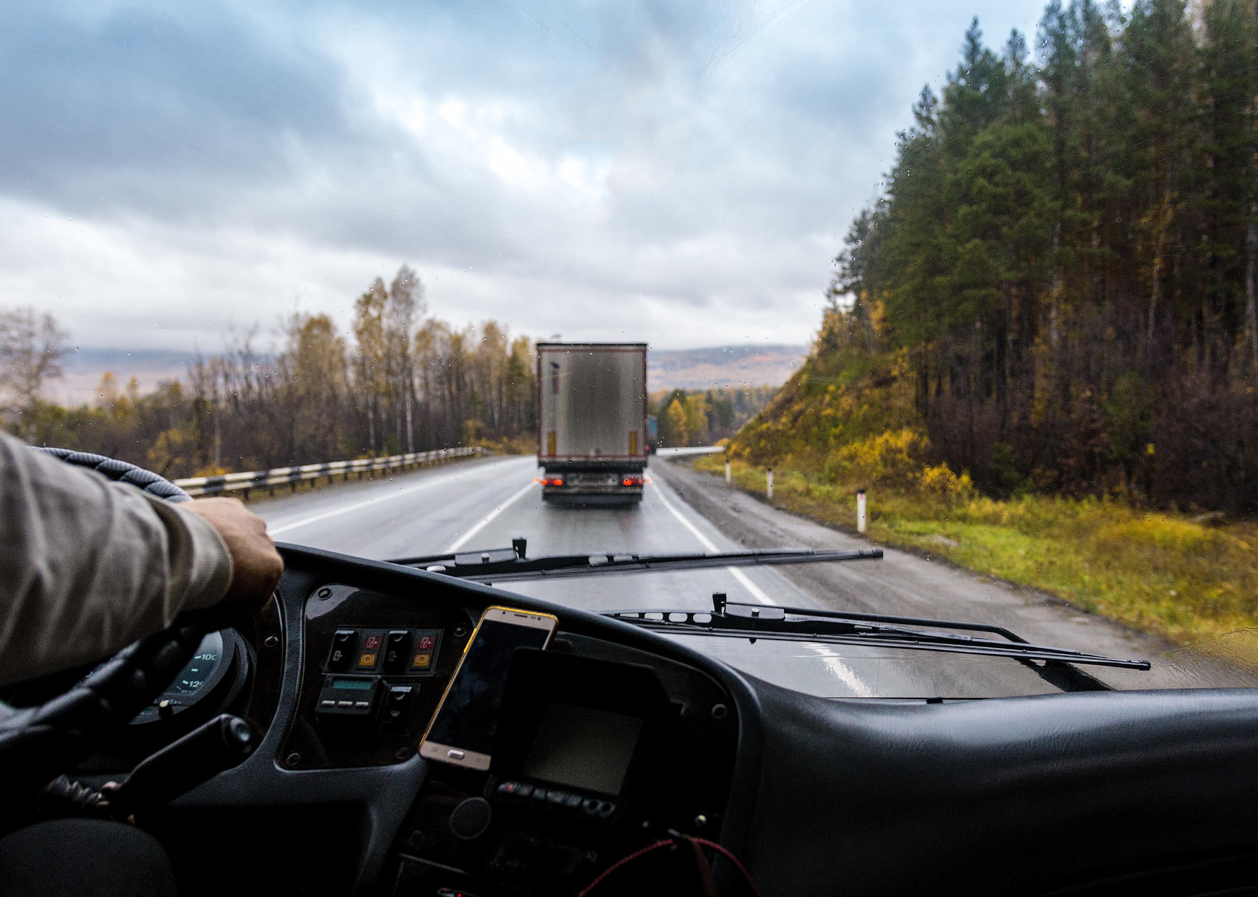 View of the highway from the vehicle cab of a truck