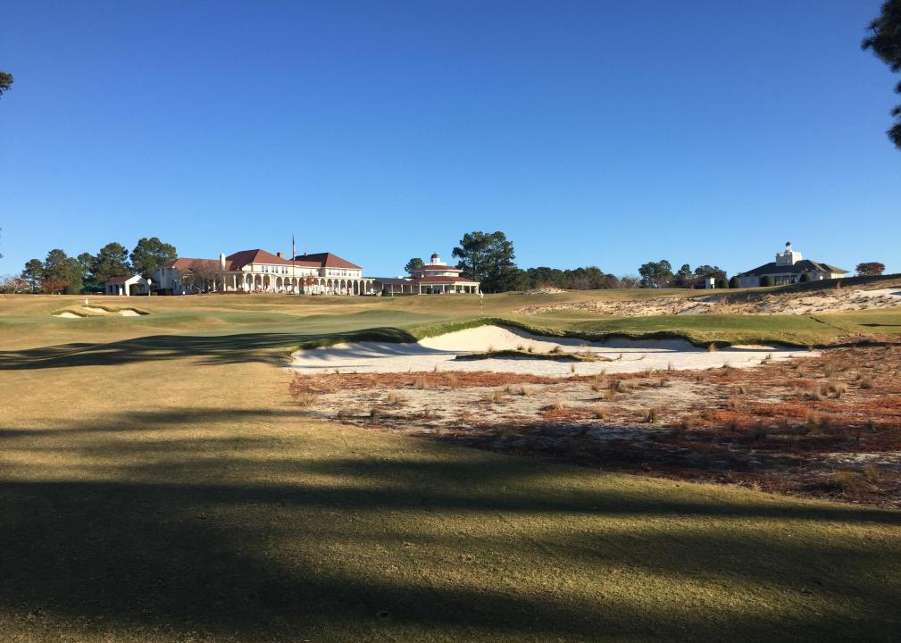 Golf course and country club on sunny day.