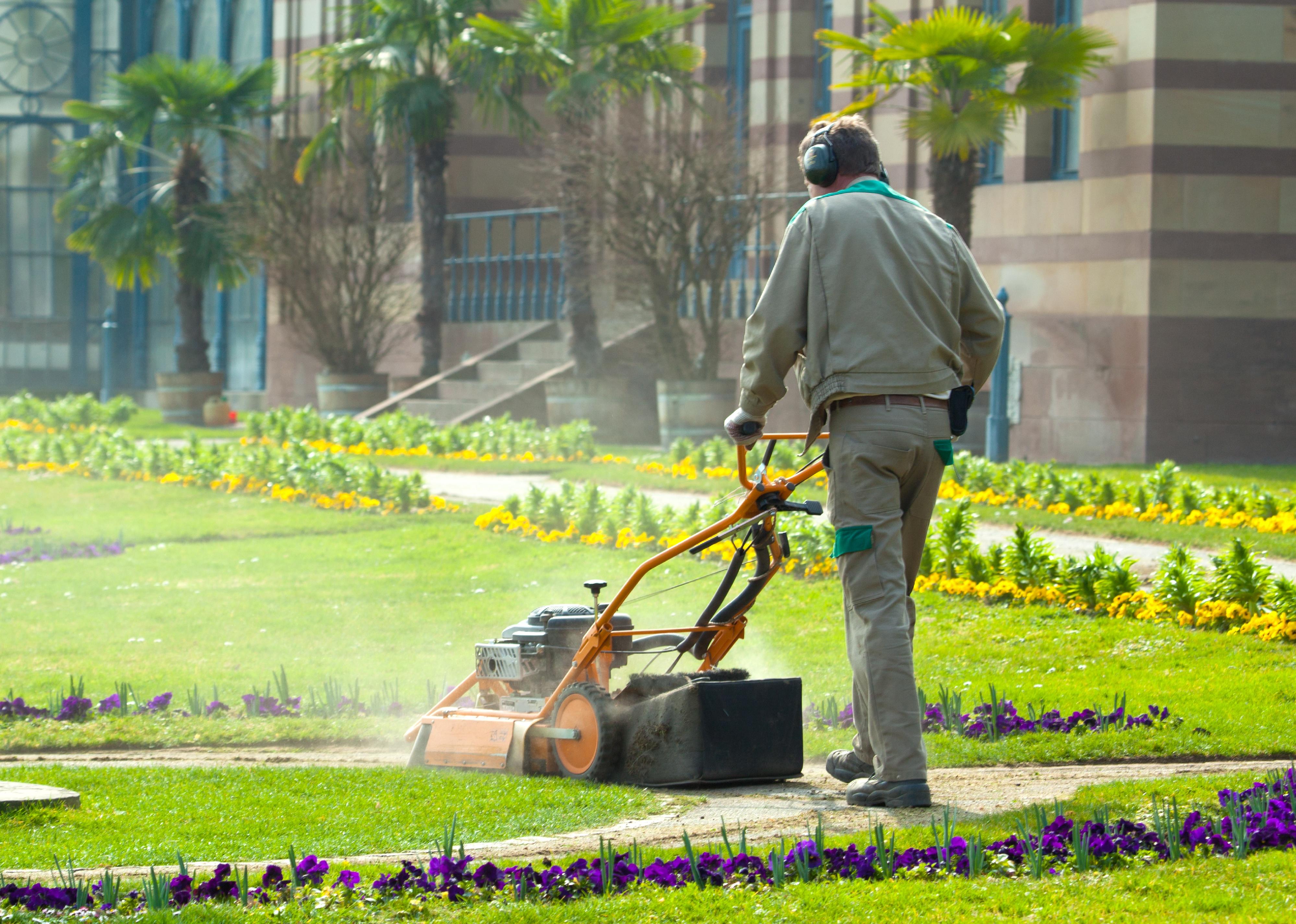 Grounds maintenance worker mows a lawn